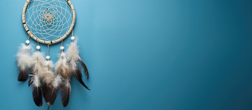 Top view of a dream catcher feature Asian attributes on a blue background with copy space image available.