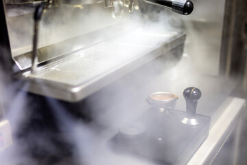 Making A Shot of Espresso from Espresso Coffee Machine with Steam from the machine