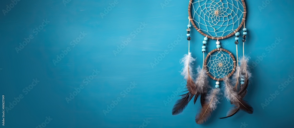 Poster Top view of a dream catcher feature Asian attributes on a blue background with copy space image available.