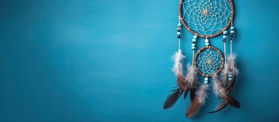 Top view of a dream catcher feature Asian attributes on a blue background with copy space image available.