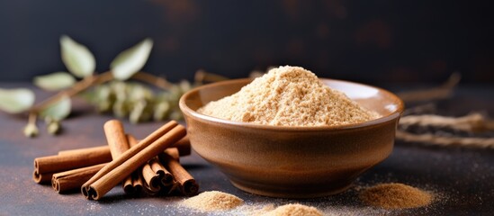 Homemade cinnamon sugar in a bowl on a textured background with brown sugar, a versatile spice blend perfect for drinks and baking, alongside ample copy space image.