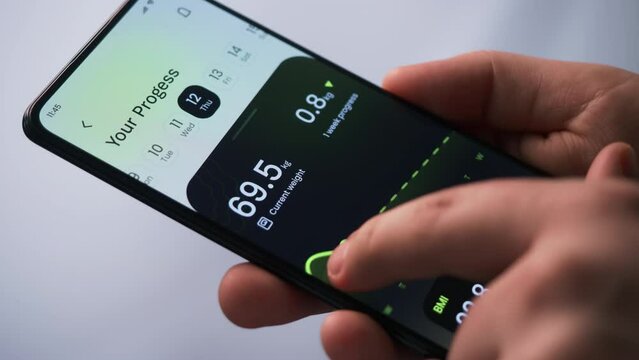 Tracking weight loss progress. Monitoring weight loss using fitness app for mobile phone. Fictional Interface.