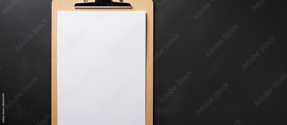 Poster Close-up view of a clipboard with a blank paper, set against a dark gray background with copy space image.