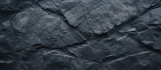 Bird's-eye view of a dark stone background, offering ample free space for additional elements in the image.