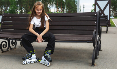 Roller blades. Roller skating girl kid in park rollerblading on inline skates.