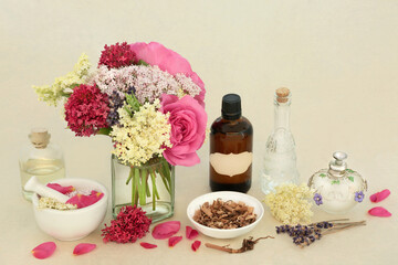 Adaptogen healing herbal medicine herbs and flowers with valerian root, rose, elder and lavender. Medicinal sedative food ingredients on hemp paper with tincture, oil and water bottles.