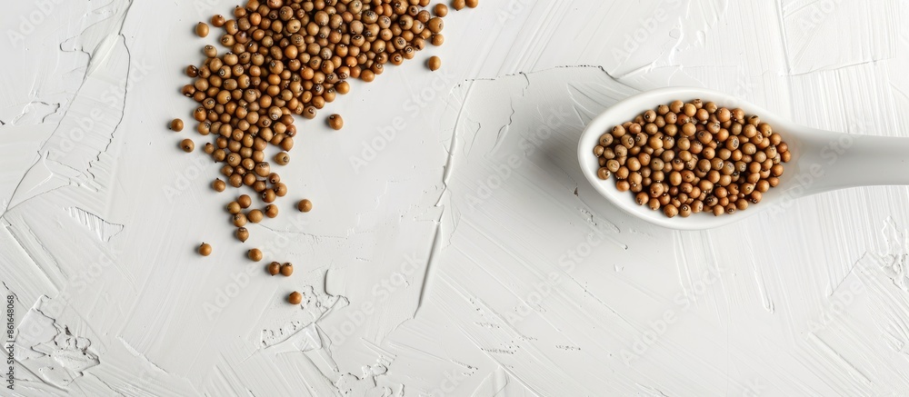 Aufkleber brassica hirta mustard seeds in a white spoon on a white background in a studio shot with soft light