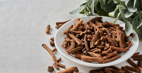 closeup dry dandelion root in white bowl on table food background copy space. 