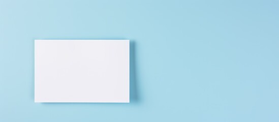 Fototapeta premium Front view of a card with a question mark on a pastel blue background, offering copy space image for text, plans, thoughts, or decision-making ideas.