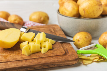 Young potatoes. Fresh potatoes  on a wooden background.Harvesting collection. organic, freshly dug potatoes. Agricultural background. Vegan. Vegetables.Place for text.Copy space