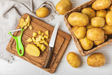 Young potatoes. Fresh potatoes  on a wooden background.Harvesting collection. organic, freshly dug potatoes. Agricultural background. Vegan. Vegetables.Place for text.Copy space