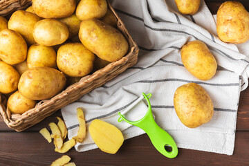 Young potatoes. Fresh potatoes  on a wooden background.Harvesting collection. organic, freshly dug potatoes. Agricultural background. Vegan. Vegetables.Place for text.Copy space