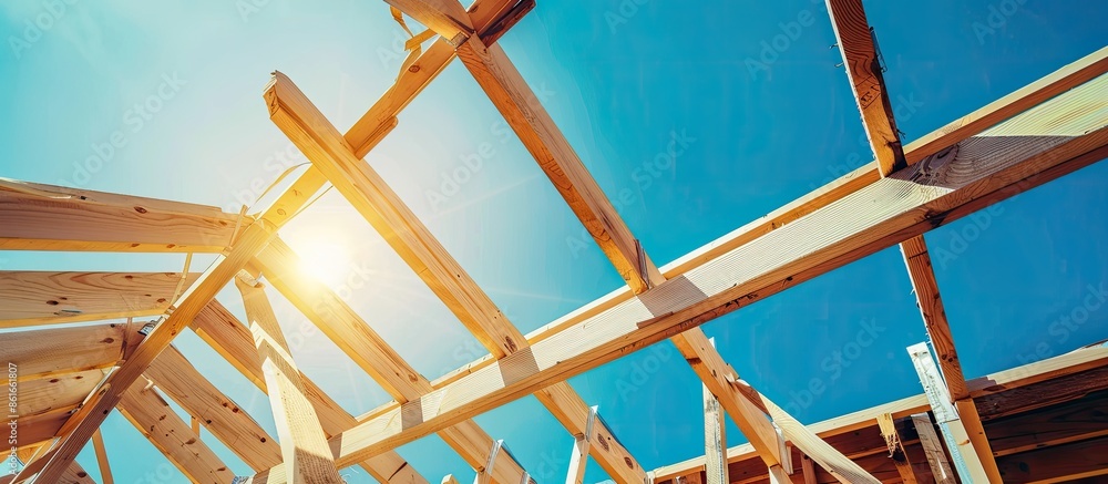 Poster looking up at new construction beams under a clear blue sky with sunlight. with copy space image. pl