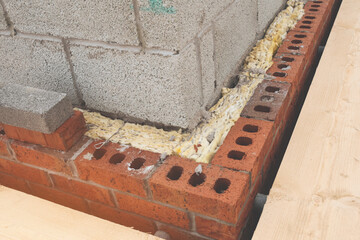 Brick Wall Corner With Foam Insulation And Wood Plank