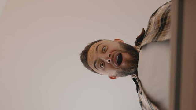 Capture the thrill of unboxing from a unique perspective, showcasing a man exuberantly opening a delivery box, encapsulating the joy of receiving a new order.