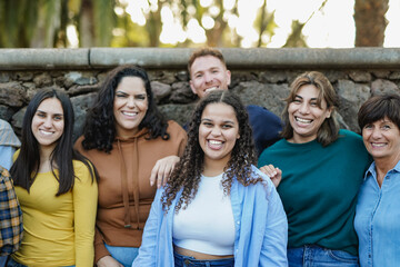Group of multi generational people having fun together outdoor while smiling on camera -...