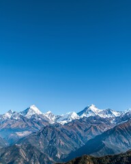 Obraz premium Majestic Snow-Capped Peaks of the Himalayan Mountains Under Clear Blue Sky