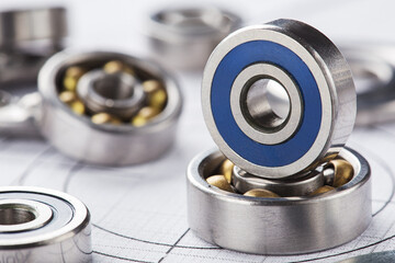 Obraz premium different bearings on blue print background. Part of mechanism.
