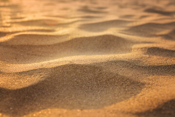 Sand with shadows from waves on the beach background