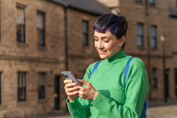 Woman Uses Smartphone in Front of New Property on Sunny Day