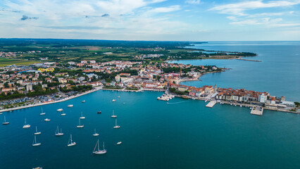 Fototapeta premium A stunning aerial view of Umag, a charming coastal town in Istria, Croatia. Known for its beautiful beaches, historic architecture, and vibrant marina, Umag offers a perfect blend of relaxation