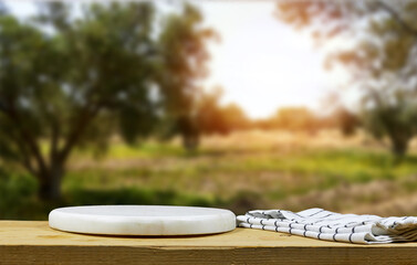 white marble board with napkin near olives field view. Healthy cooking concept with copy space 