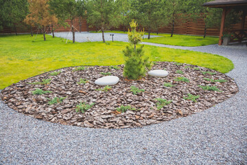 Obraz premium Decoration zone outdoors near the house with pine tree.