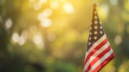 A photograph of the American flag with sunlight shining through the leaves in the background, creating a warm and serene atmosphere.