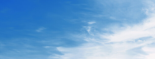clear blue sky with a few clouds. The sky is very bright and the clouds are scattered throughout