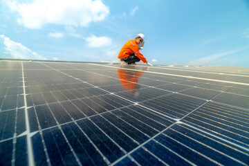 engineer man inspects construction of solar cell panel or photovoltaic cell by electronic device. Industrial Renewable energy of green power. factory worker working on tower roof.