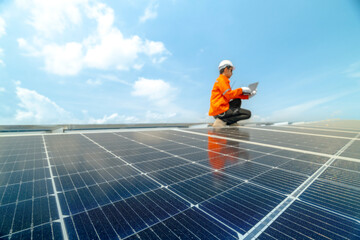 engineer man inspects construction of solar cell panel or photovoltaic cell by electronic device....