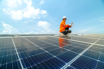 engineer man inspects construction of solar cell panel or photovoltaic cell by electronic device....