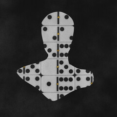 States of mind, psychology, fine art concept. Artistic silhouette of a person made with black and white dominoes on a dark background. Grunge and noise effect applied