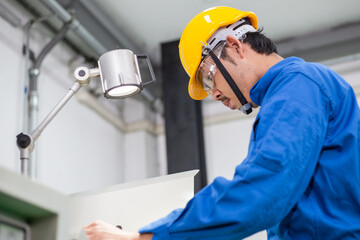 experienced operator technician worker or engineer metalworker industrial in safety helmet working or repair on metal machine, professional maintenance skill man in industry manufacturing. men at work