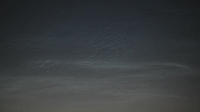 Time lapse of moving noctilucent clouds or NLC during the period of the shortest nights. Small waves and whirls of electric blue night time clouds at a height of approximately 70 kilometers.