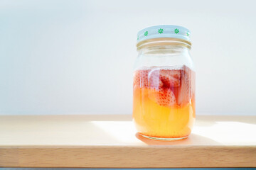 白バックに発酵が進んで炭酸ガスの気泡が多く出ている苺の手作り天然フルーツ酵母液