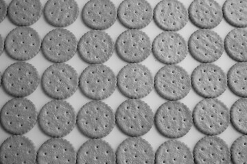 Saltine crackers on pink background  top view, black and white photo