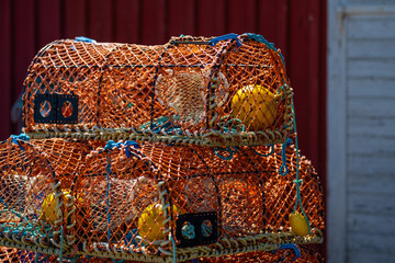 Lobster cages stacked on land.
