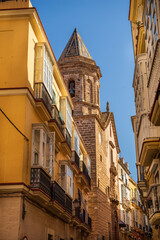 View of an old church overlooking a narrow street in Cadiz,Spain