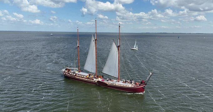 a clipper sail ship in a sailing cruise on the IJsselmeer at the daytime in the Netherlands