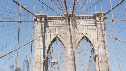 Obraz premium Brooklyn Bridge to Manhattan downtown, cables and blue sky. New York City iconic symbol, USA travel destination. Architecture of United States of America, tourist landmark. Famous cable-stayed bridge.