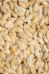 Close-up of unpeeled pumpkin seeds from above.