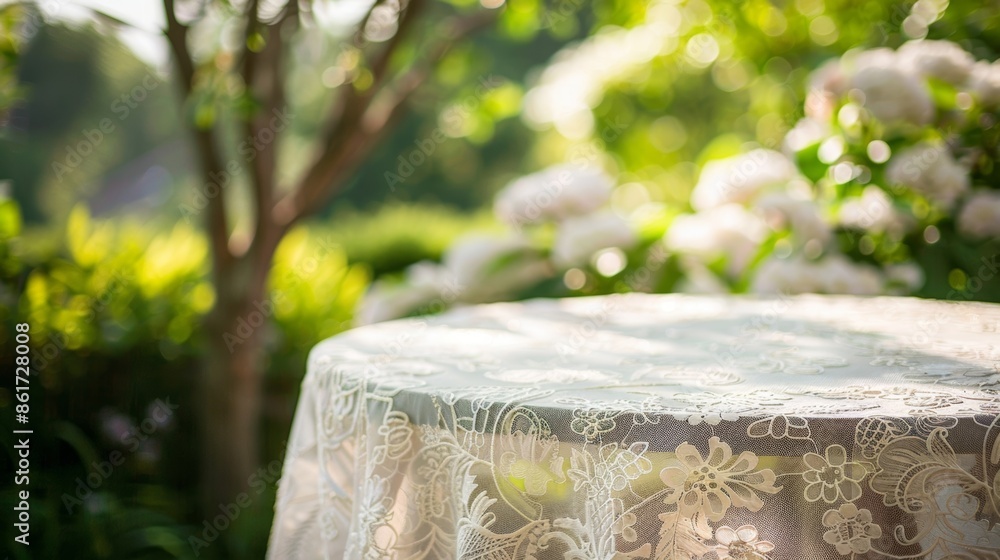 Poster a delicate lace tablecloth flutters atop a garden table adding a touch of elegance and texture to th