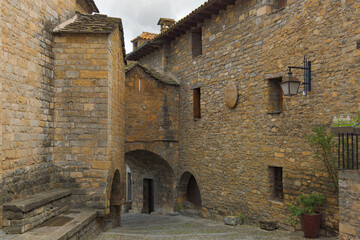 Un rinc&oacute;n pintoresco del centro hist&oacute;rico de Ainsa, Arag&oacute;n, Espa&ntilde;a, presenta una encantadora escena de arquitectura medieval. 