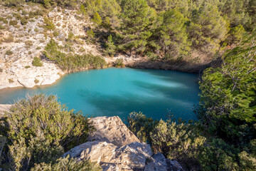 Small bluish lake at the source of Fuente Caputa in Mula, Region of Murcia, Spain, with daylight