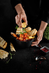 Chef Garnishing Seafood Saute in Tomato Sauce with Ciabatta