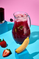 Refreshing Berry Lemonade with Mint in Pitcher on Colorful Background
