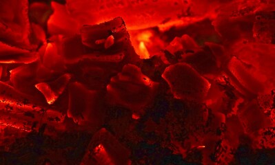 Red hot coals from remnants of a roaring fire