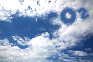 Blue sky with CO2 chemical formula and clouds. Carbon dioxide emissions