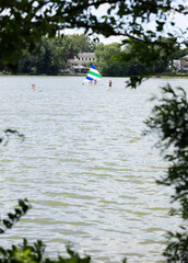 Paddle boarding and sailing on a lake 